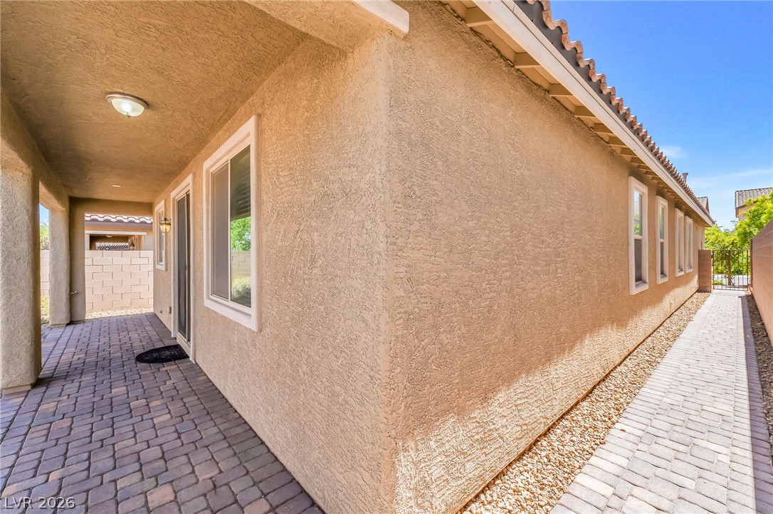 6245 Andover Wood Road Las Vegas, NV 89113 - Photo 34 of 37 A private side patio features durable pavers and ample space for outdoor enjoyment.