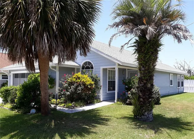 a front view of house with yard and swimming pool