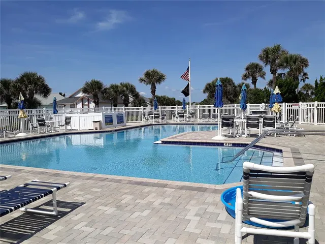 a view of a swimming pool with outdoor seating