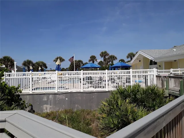 a view of a balcony with wooden fence
