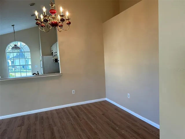 a view of a chandelier fan and wooden floor