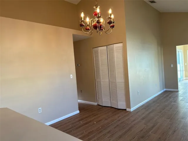 a view of a room with wooden floor
