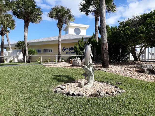 a front view of a house with garden and patio