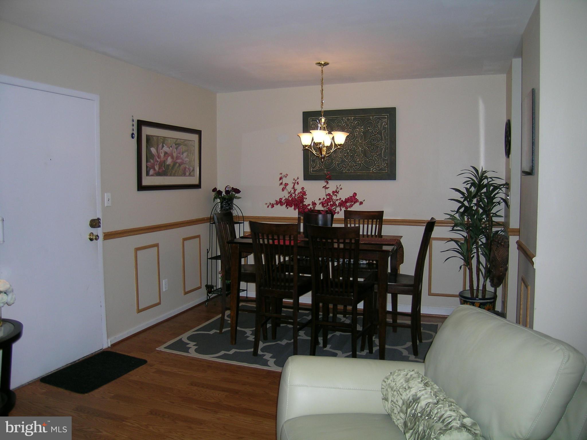 5907 Bayshire Road, Unit 189 Springfield, VA 22152 - Photo 11 of 21 a view of a dining room with furniture and wooden floor