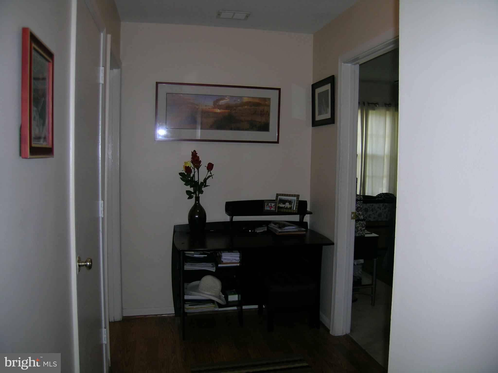 5907 Bayshire Road, Unit 189 Springfield, VA 22152 - Photo 12 of 21 a room with painting on the wall and a table