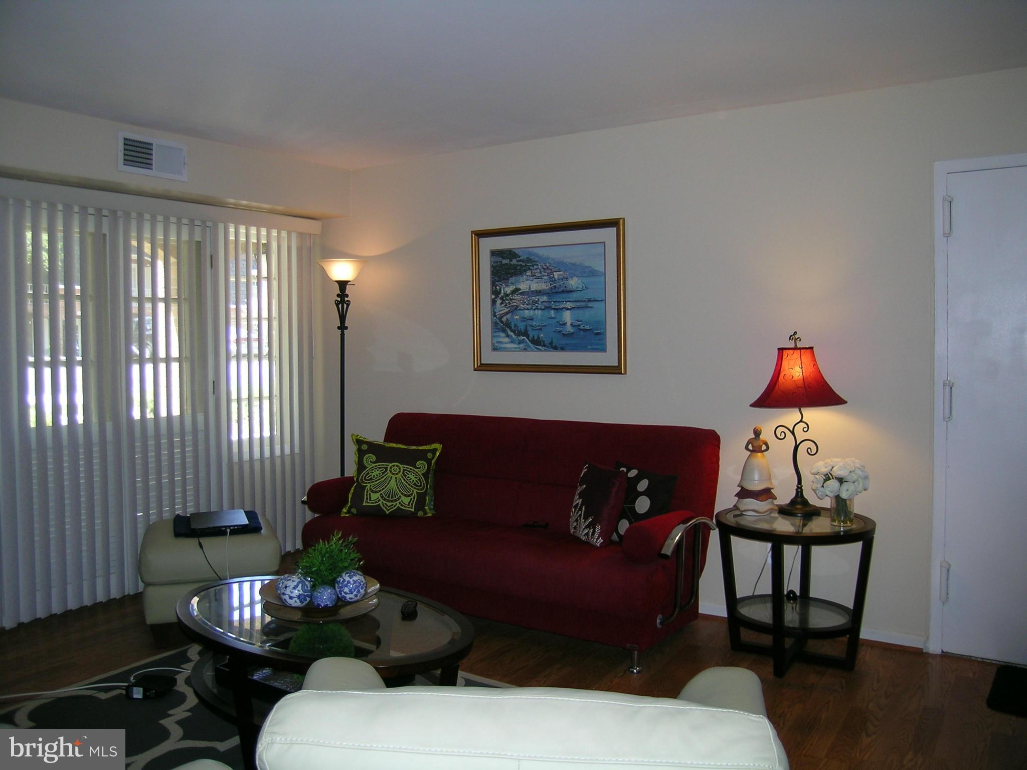 5907 Bayshire Road, Unit 189 Springfield, VA 22152 - Photo 18 of 21 a living room with furniture and wooden floor
