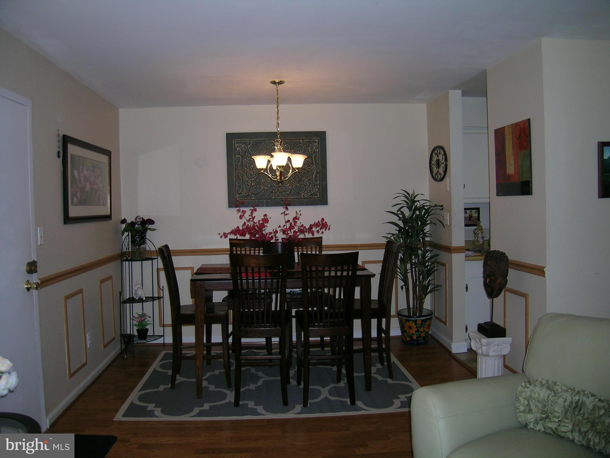 5907 Bayshire Road, Unit 189 Springfield, VA 22152 - Photo 4 of 21 a view of a dining room with furniture and chandelier