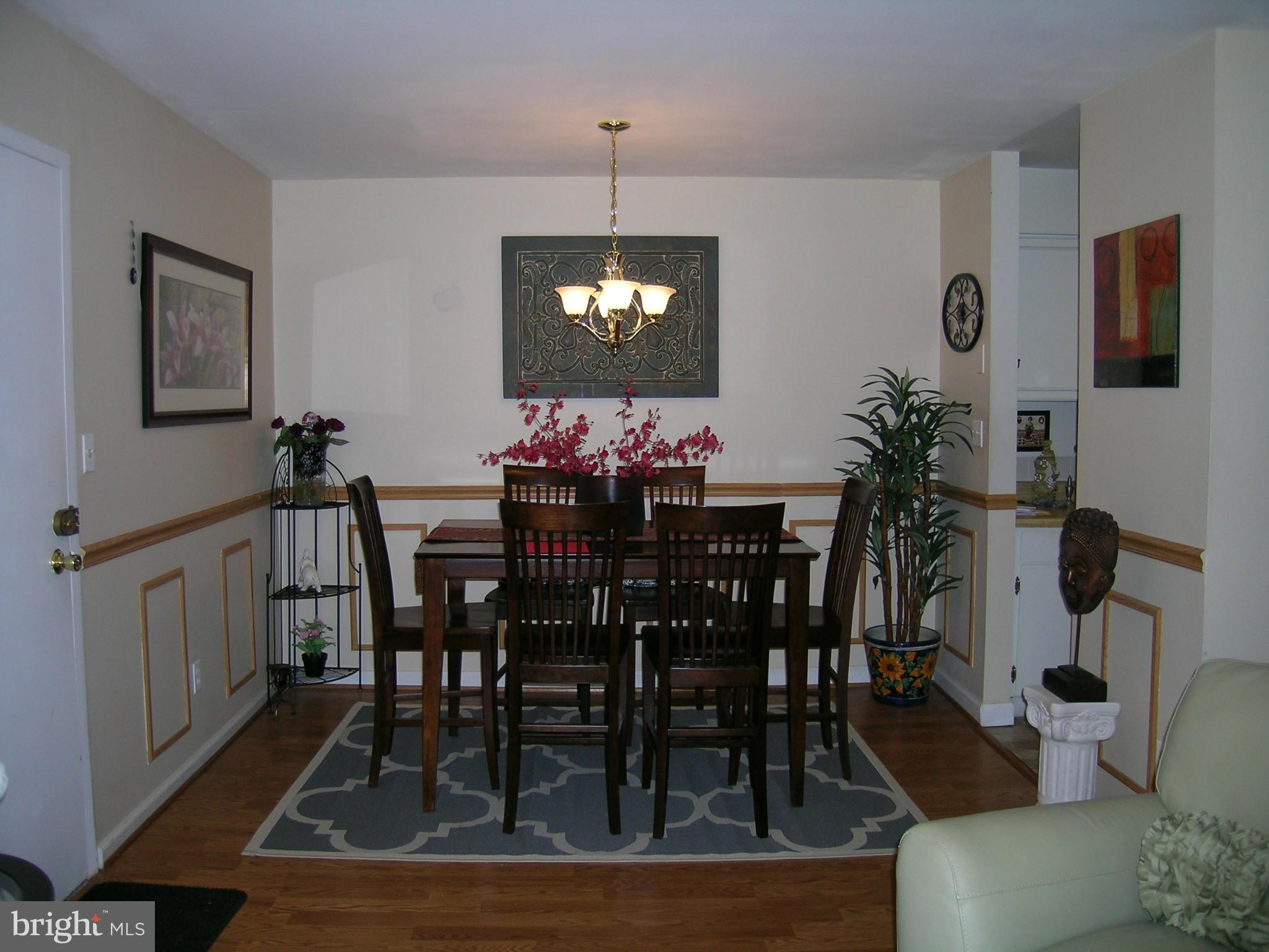 5907 Bayshire Road, Unit 189 Springfield, VA 22152 - Photo 5 of 21 a view of a dining room with furniture and wooden floor