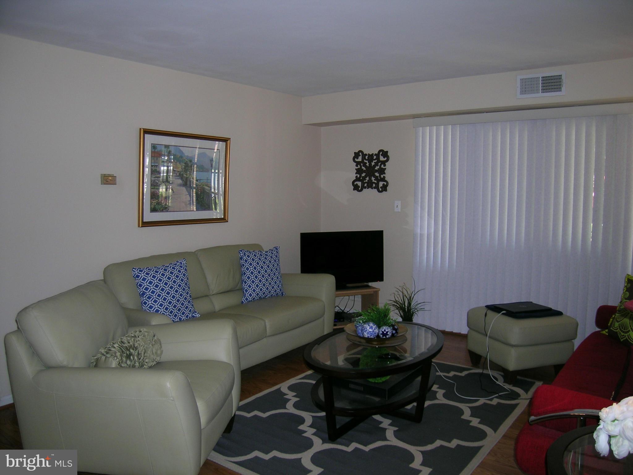 5907 Bayshire Road, Unit 189 Springfield, VA 22152 - Photo 10 of 21 a living room with furniture and a flat screen tv