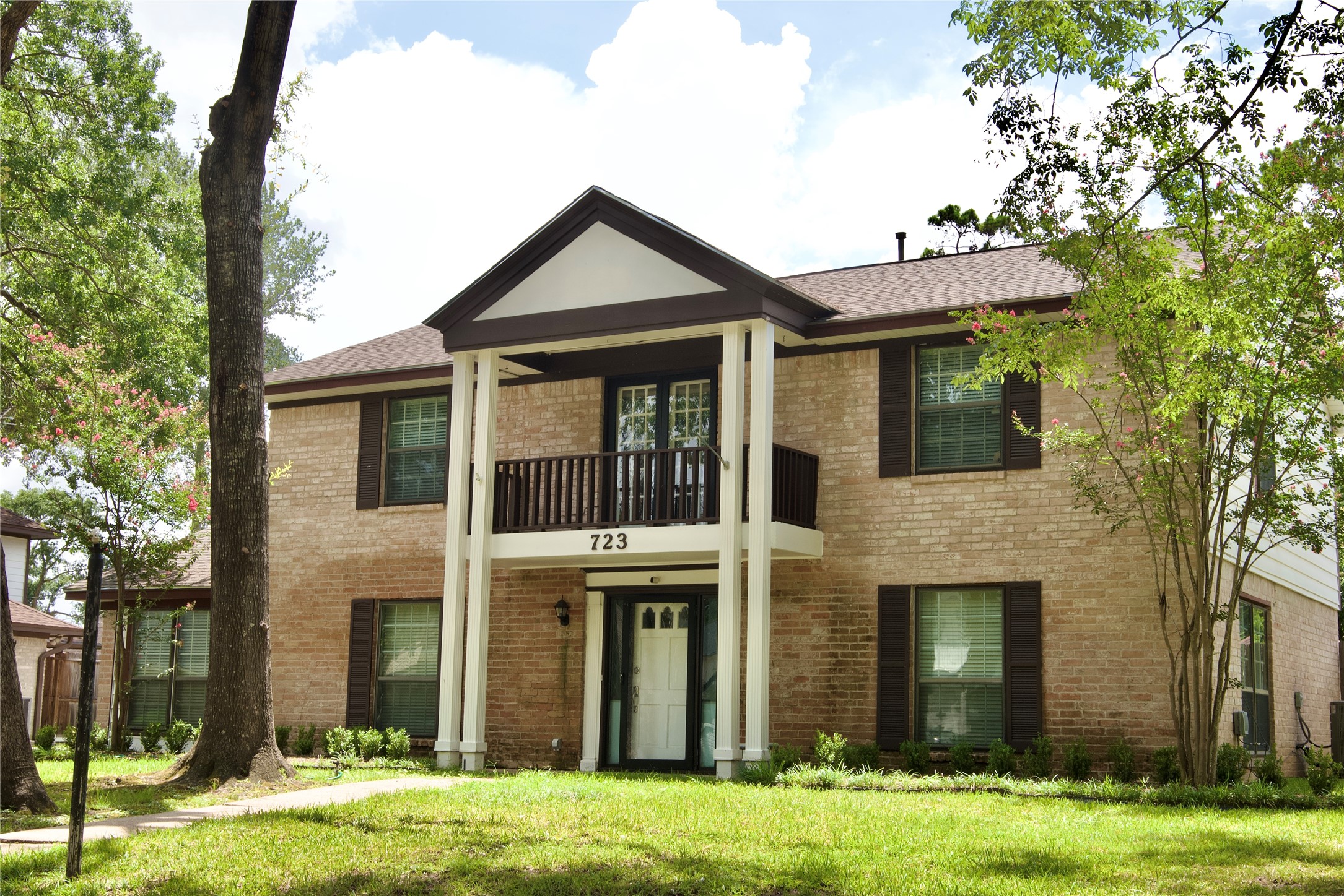a front view of a house with a yard