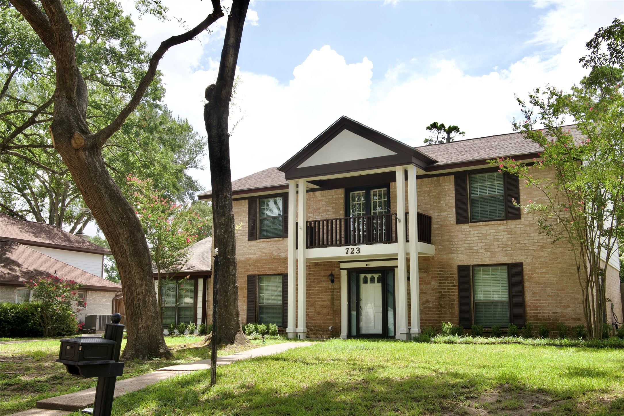 723 Leaflet Lane Spring, TX 77388 - Photo 2 of 41 a view of a brick house with a yard and large trees