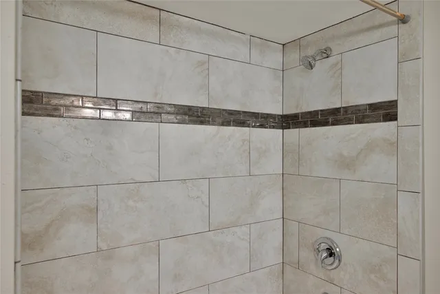 a bathroom with a granite countertop sink and shower