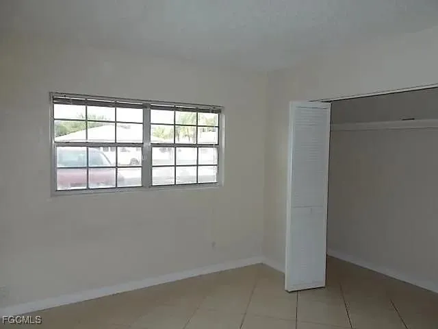 an empty room with a empty space and window