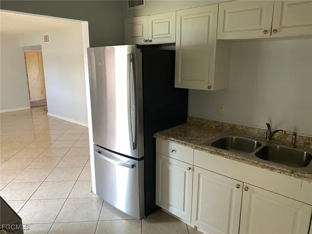 a kitchen with a refrigerator and cabinets