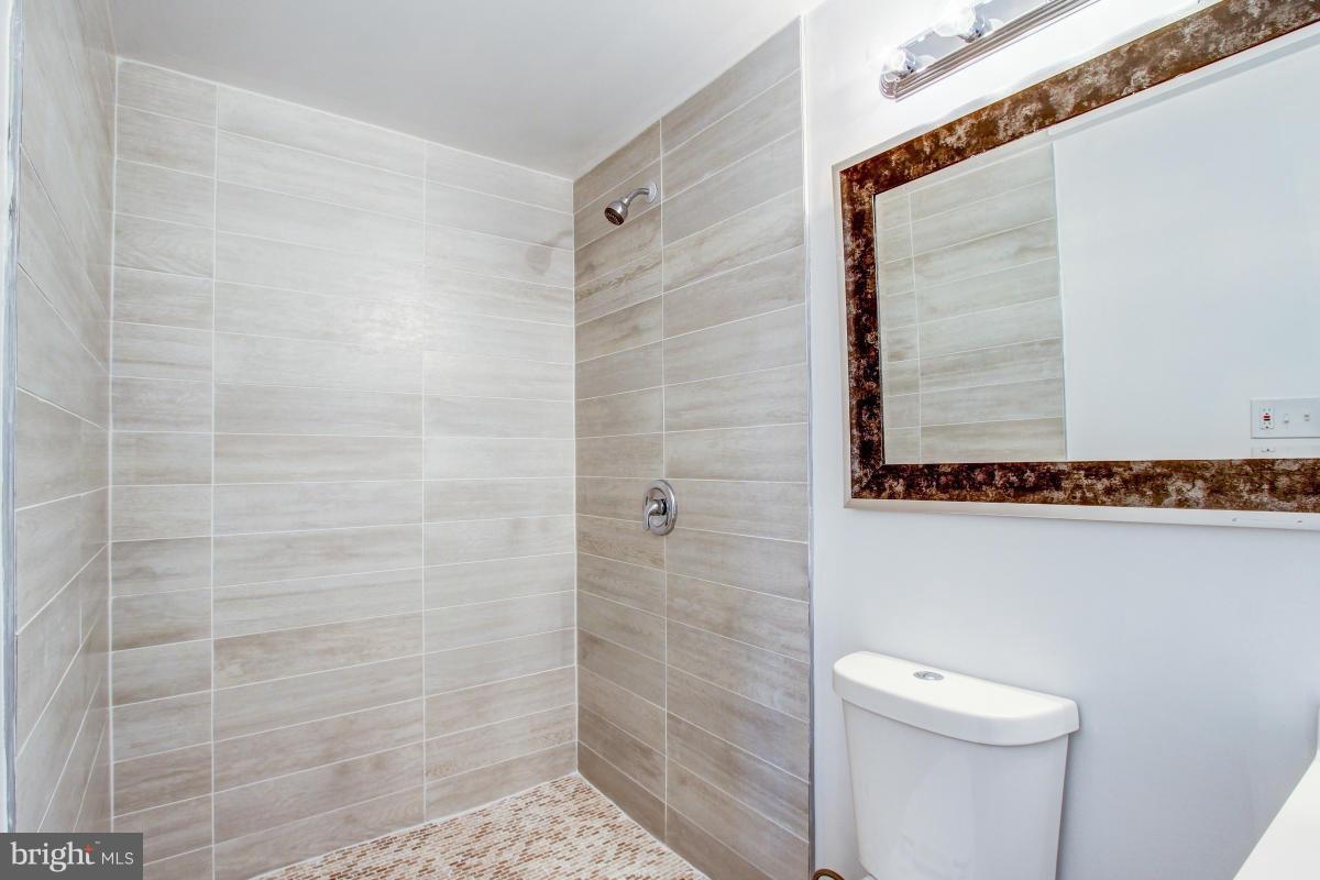3101 Tucker Road Fort Washington, MD 20744 - Photo 14 of 30 a bathroom with a shower and a toilet