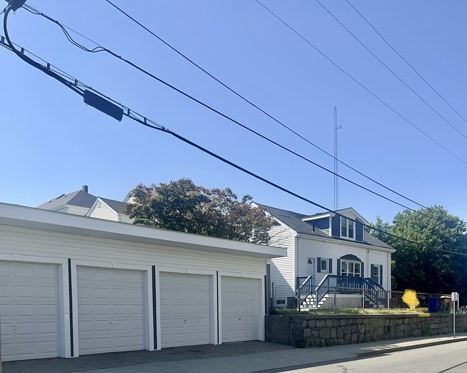73 Brow Street Fall River, MA 02721 - Photo 1 of 9 a view of a house with a small yard and wooden fence