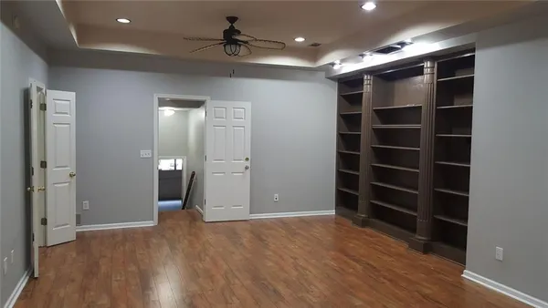 a view of an empty room with a cabinet and a window