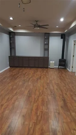a view of a room with wooden floor