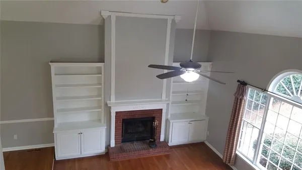a view of a livingroom with a fireplace and window