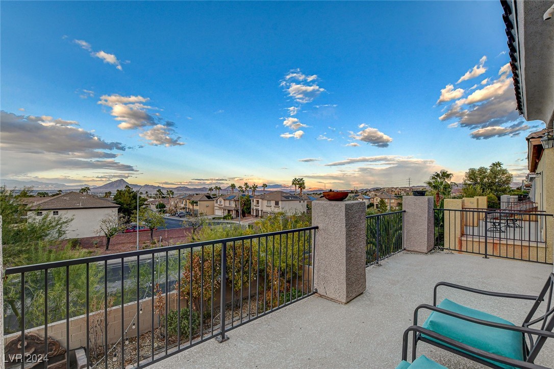 1118 Riddle Glen Street Henderson, NV 89012 - Photo 43 of 82 Primary Suite Retreat: A grand sanctuary with a private balcony offering breathtaking views of city lights, the mountains, and the Las Vegas Strip.