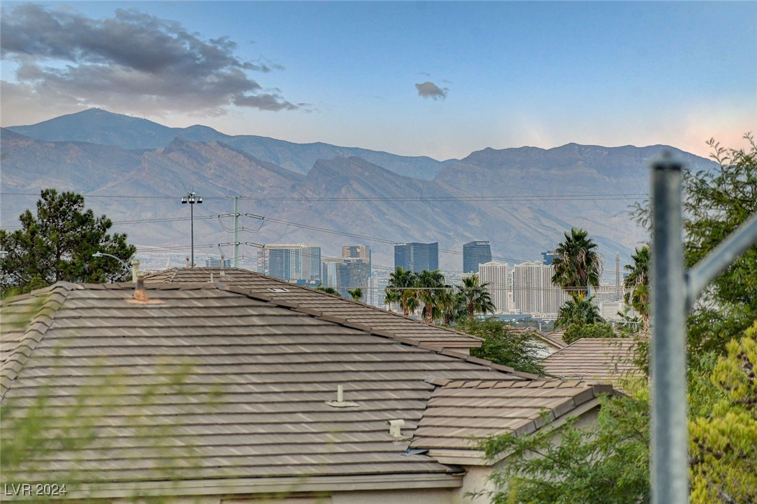 1118 Riddle Glen Street Henderson, NV 89012 - Photo 44 of 82 Primary Suite Retreat: A grand sanctuary with a private balcony offering breathtaking views of city lights, the mountains, and the Las Vegas Strip.