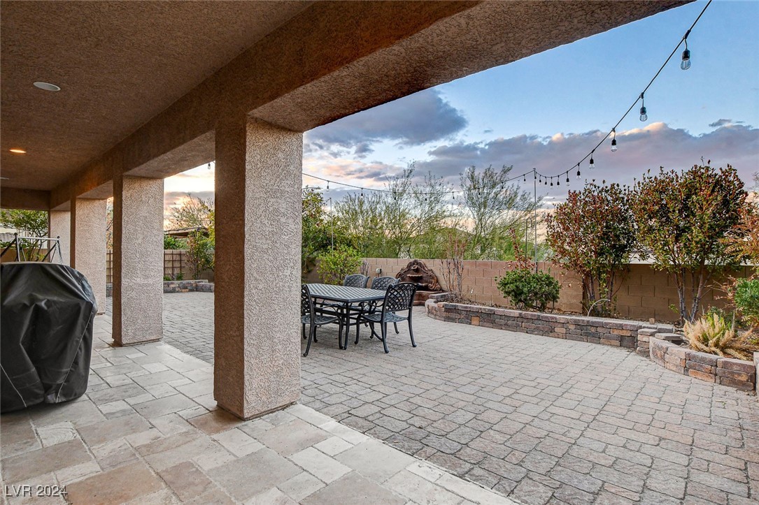 1118 Riddle Glen Street Henderson, NV 89012 - Photo 62 of 82 Outdoor Serenity: A private backyard with an expansive patio and large cover creates an ideal setting for entertaining or unwinding in the shade.