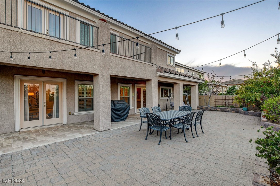1118 Riddle Glen Street Henderson, NV 89012 - Photo 8 of 82 Outdoor Serenity: A private backyard with an expansive patio and large cover creates an ideal setting for entertaining or unwinding in the shade.