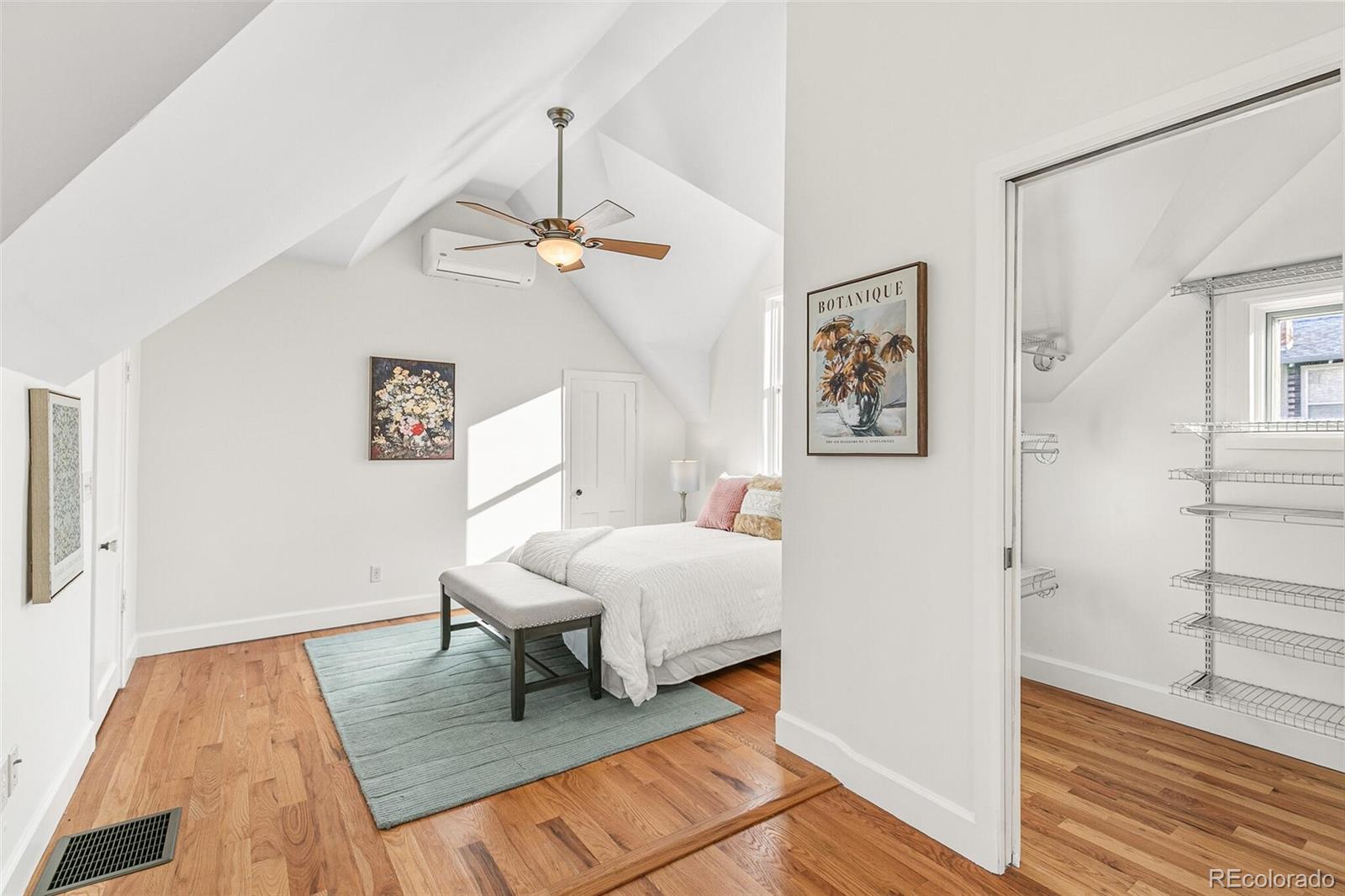 3885 Wolff Street Denver, CO 80212 - Photo 22 of 50 a spacious bedroom with a bed and a table in it