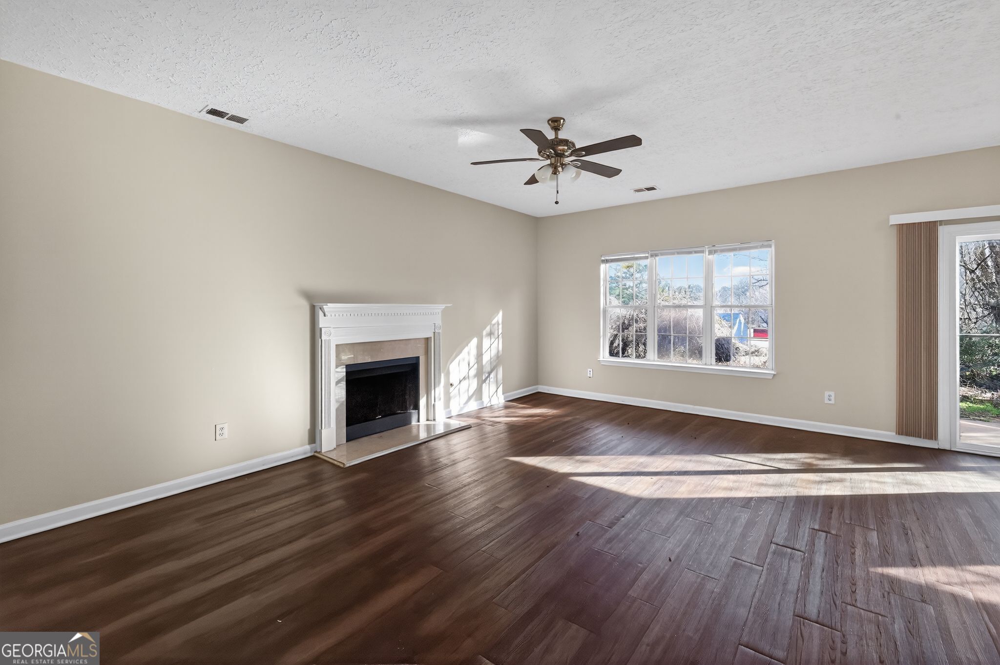 4292 Linecrest Lane Ellenwood, GA 30294 - Photo 11 of 33 a view of an empty room with a fireplace and a window