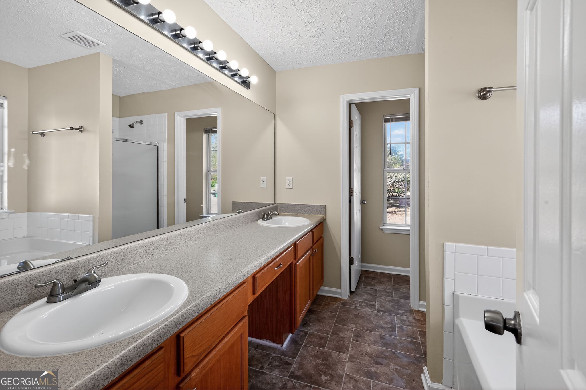 4292 Linecrest Lane Ellenwood, GA 30294 - Photo 26 of 33 a bathroom with a double vanity sink and mirror