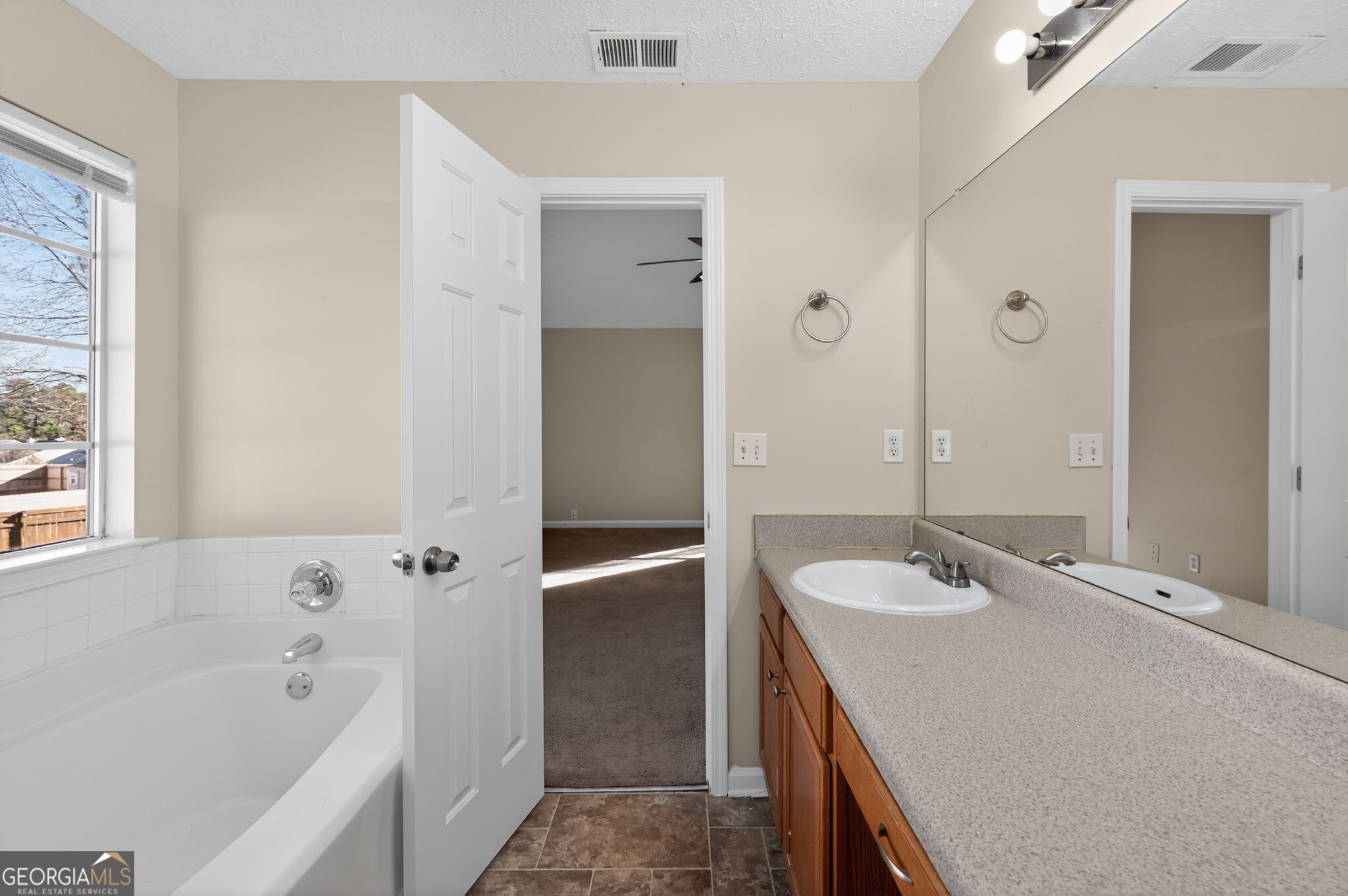 4292 Linecrest Lane Ellenwood, GA 30294 - Photo 27 of 33 a bathroom with a tub sink and mirror