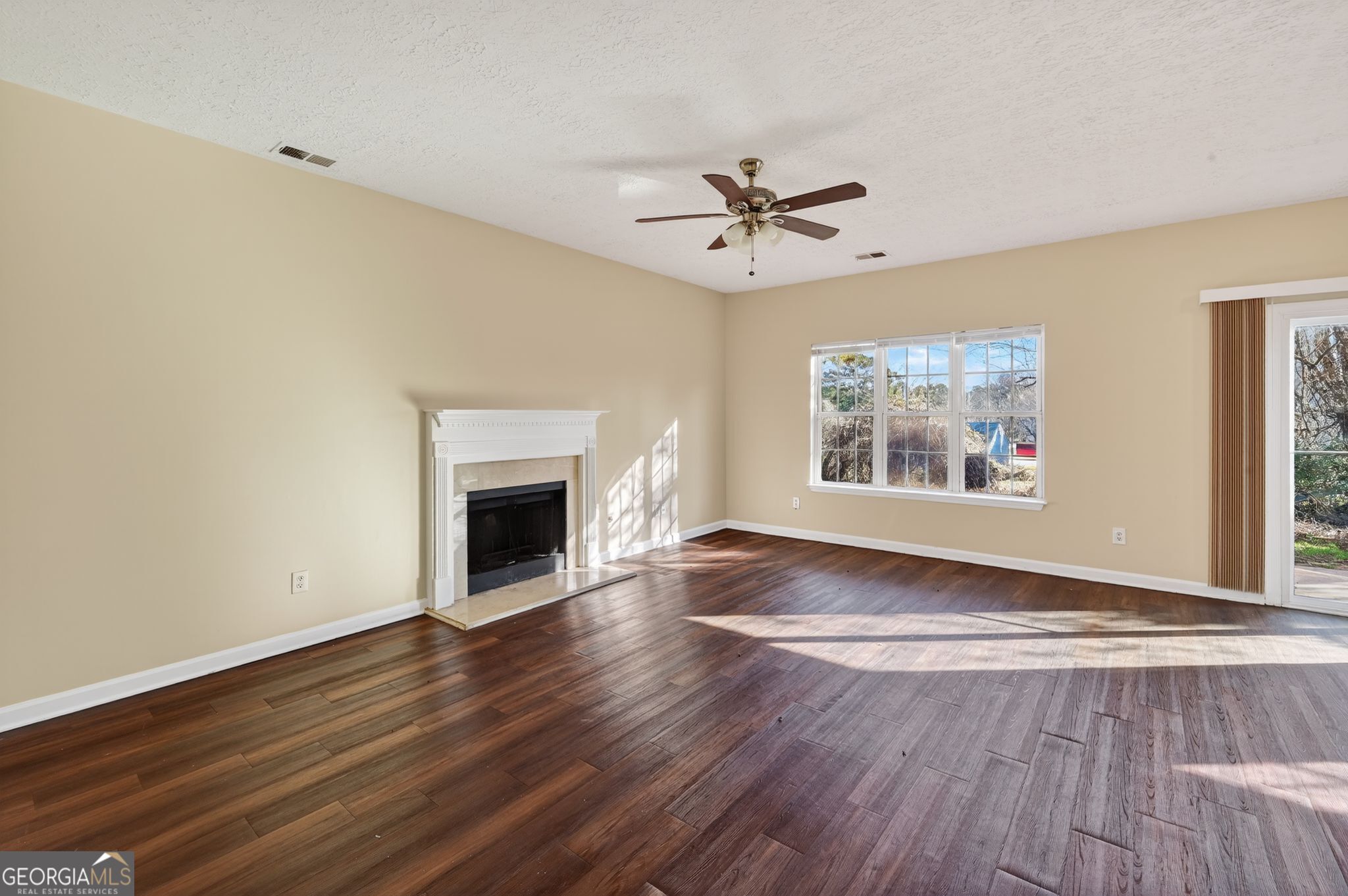 4292 Linecrest Lane Ellenwood, GA 30294 - Photo 8 of 33 a view of an empty room with a fireplace and a window