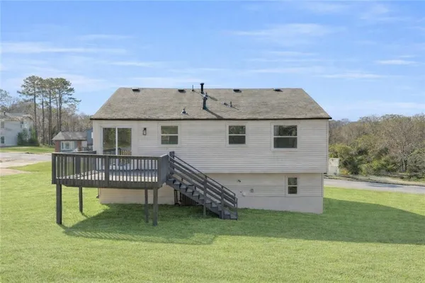 a view of a house with a balcony and wooden fence