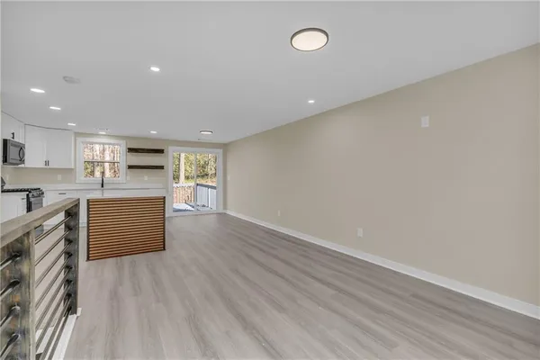 a kitchen with a wooden floor and window