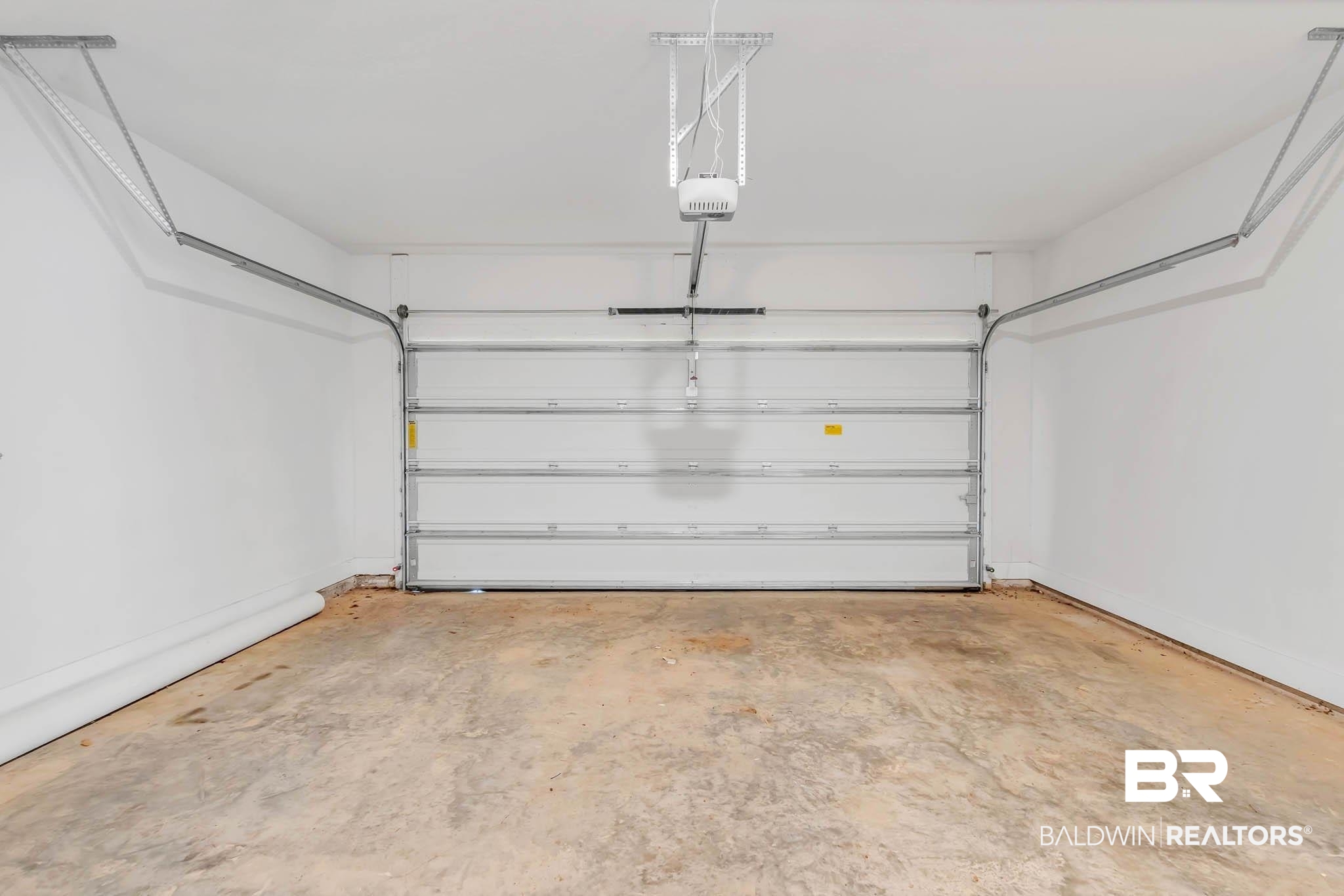 16461 Prado Loop Loxley, AL 36551 - Photo 56 of 78 Garage with baseboards and a garage door opener
