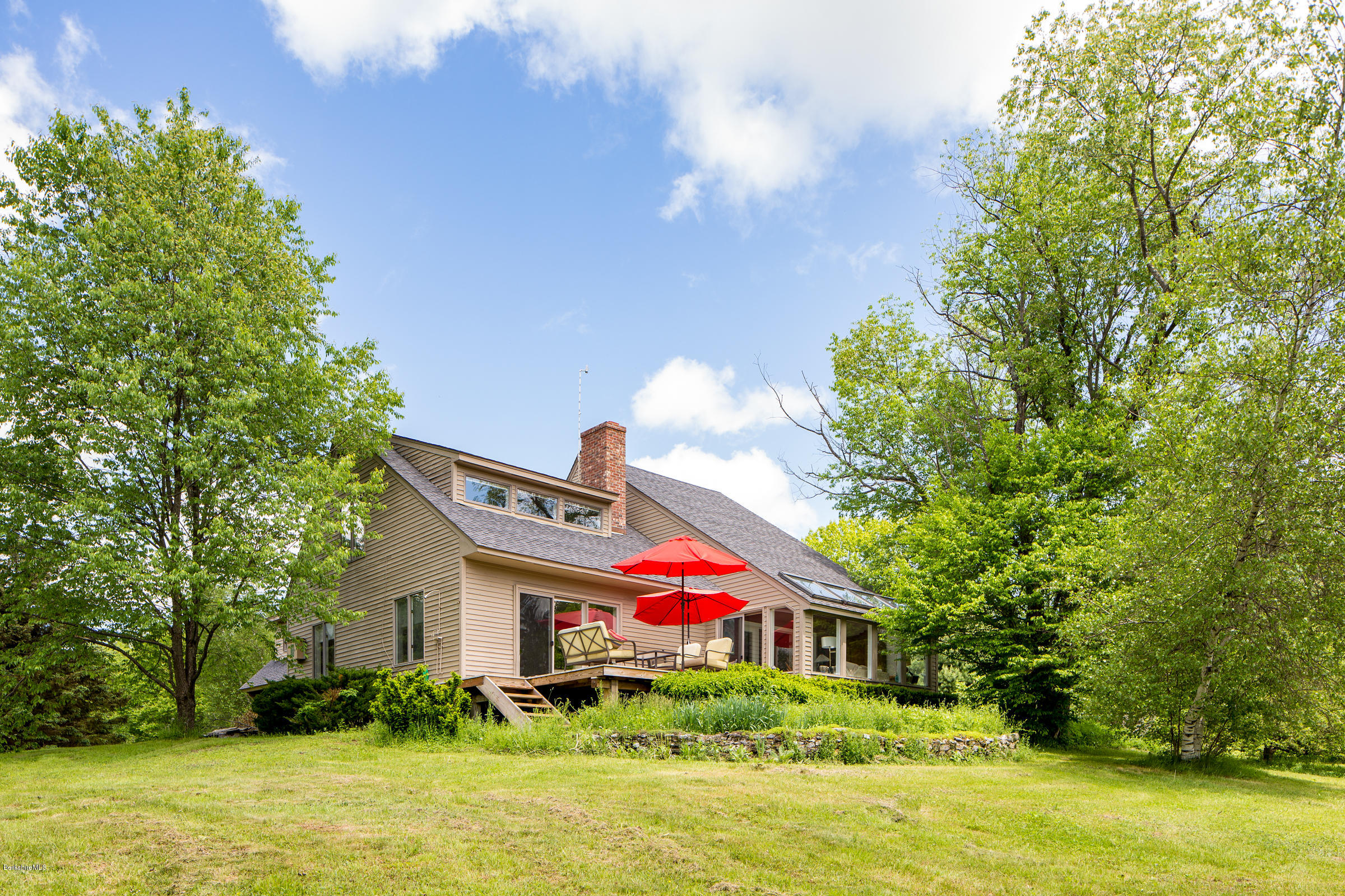 a house view with swimming pool and garden space