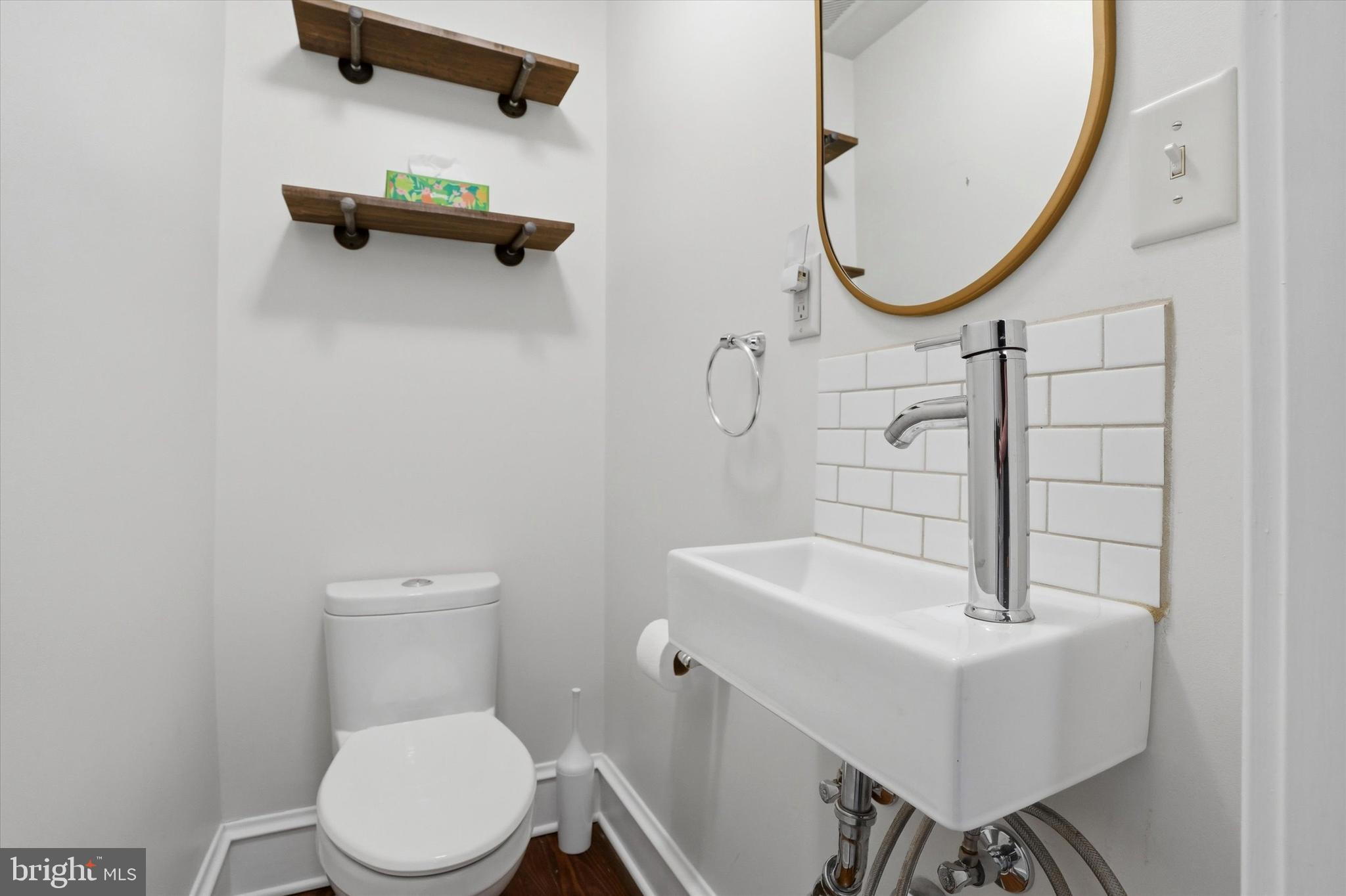 18 Vernon Road Havertown, PA 19083 - Photo 13 of 25 a bathroom with a sink a mirror a toilet and a mirror