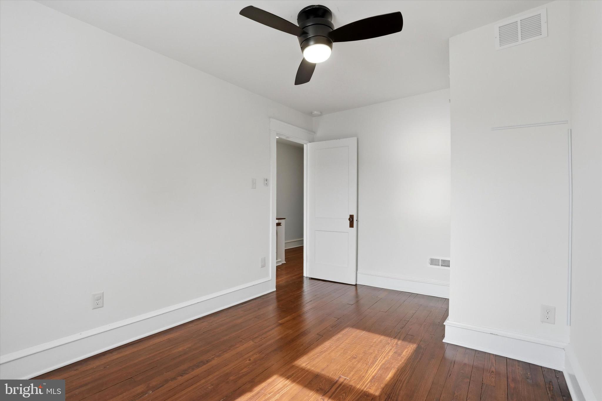 18 Vernon Road Havertown, PA 19083 - Photo 20 of 25 a view of an empty room with wooden floor