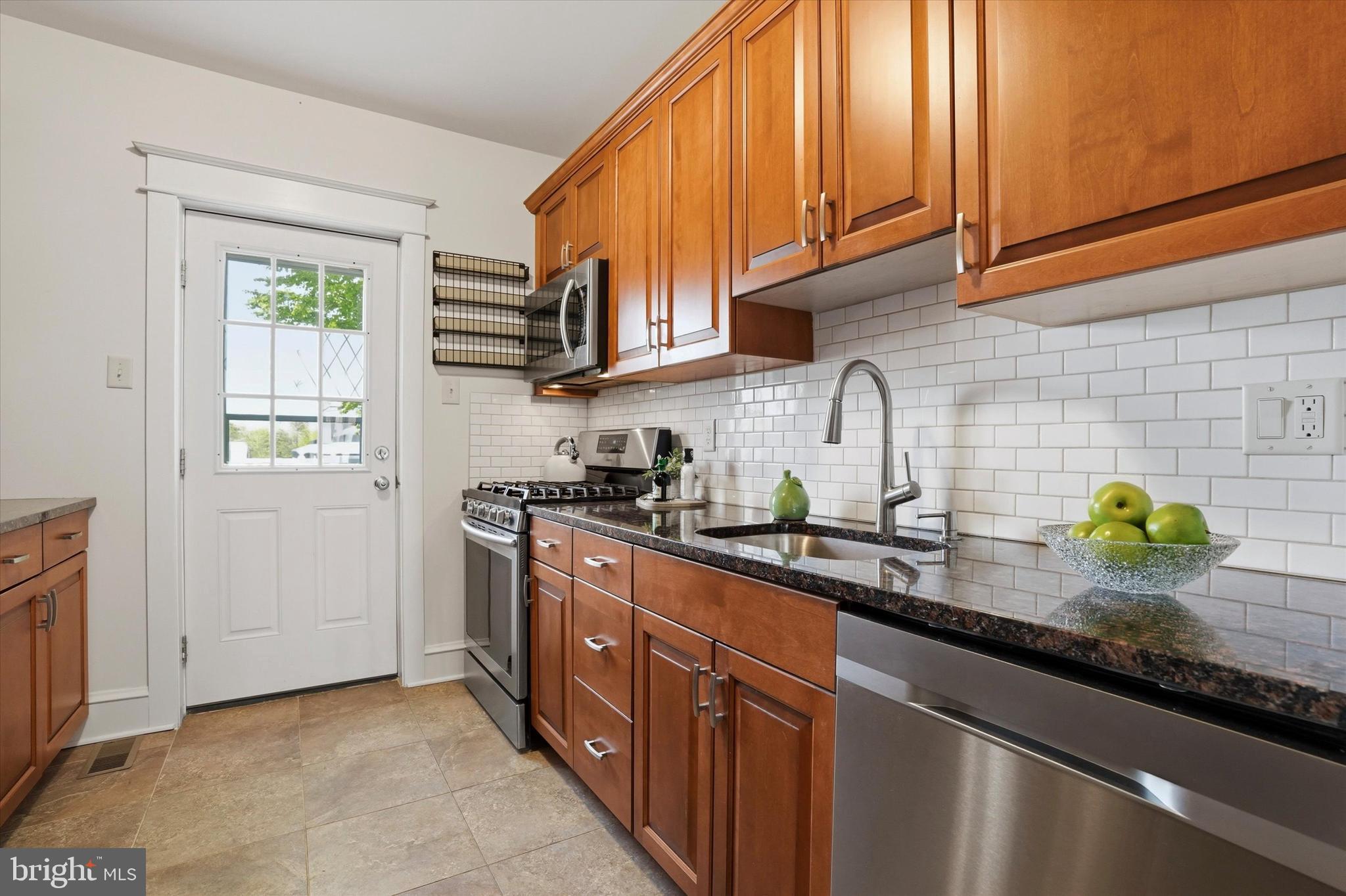 18 Vernon Road Havertown, PA 19083 - Photo 10 of 25 a kitchen with stainless steel appliances granite countertop a sink a stove and cabinets