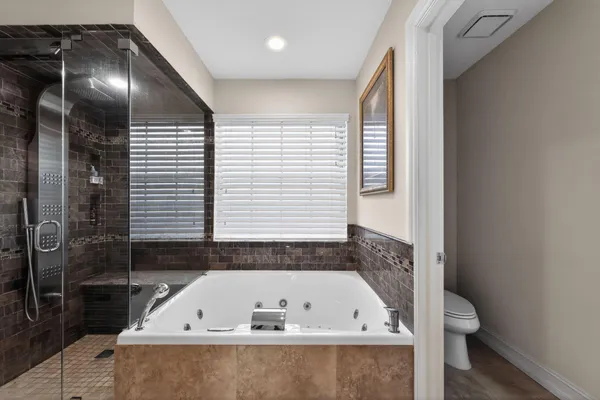 a bathroom with a granite countertop sink a large mirror and a shower