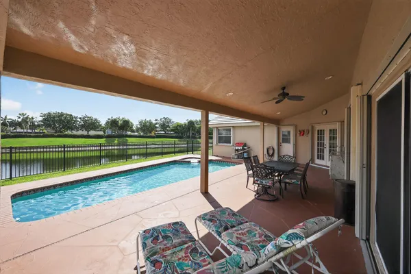 a front view of a house with a yard and lake view