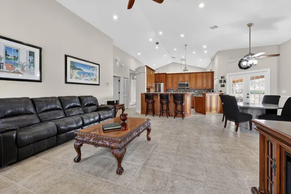 a living room with furniture and kitchen view