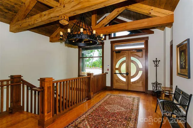 a living room with furniture a fireplace and a chandelier