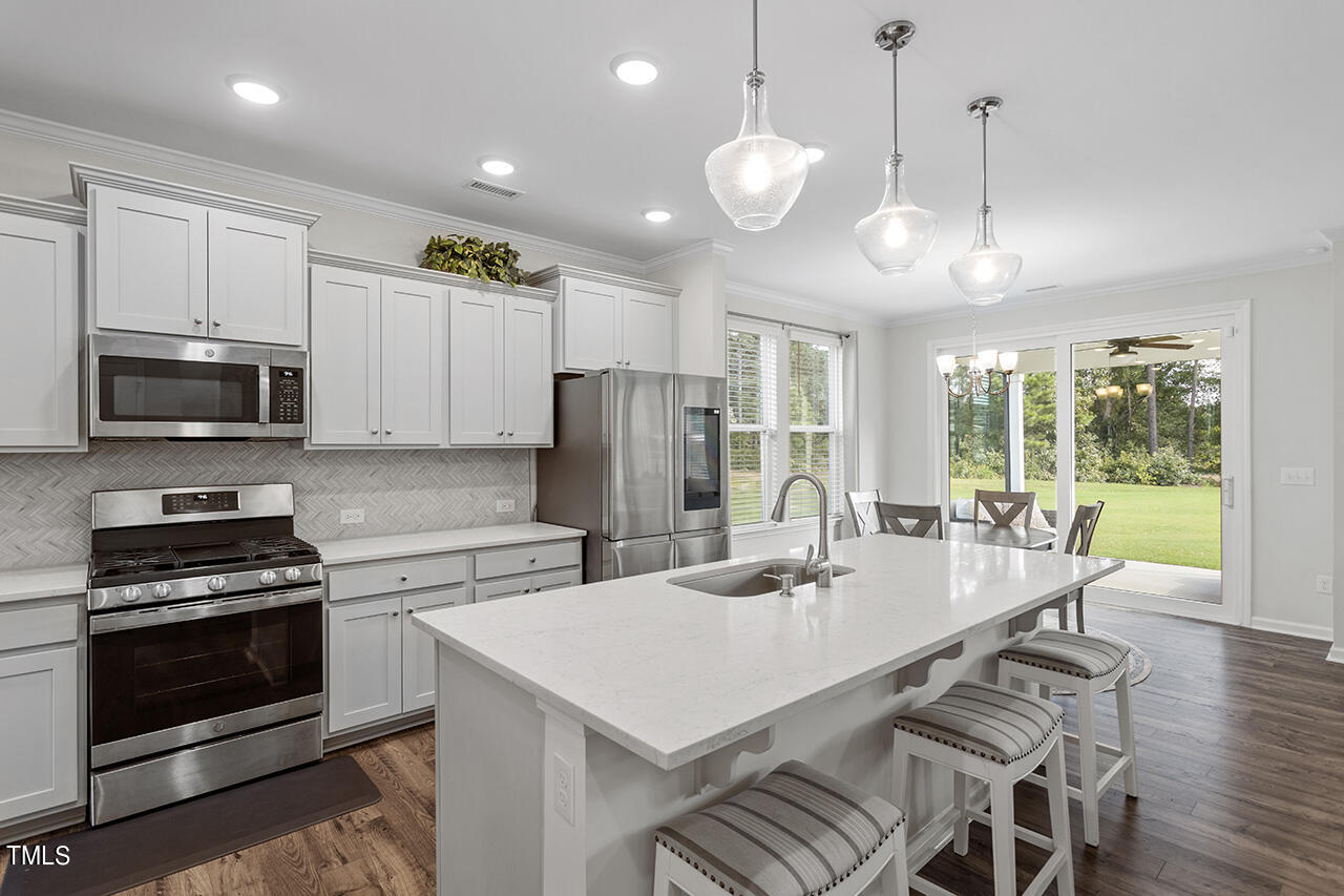131 Hopper Circle Clayton, NC 27520 - Photo 15 of 39 a large kitchen with a table and chairs