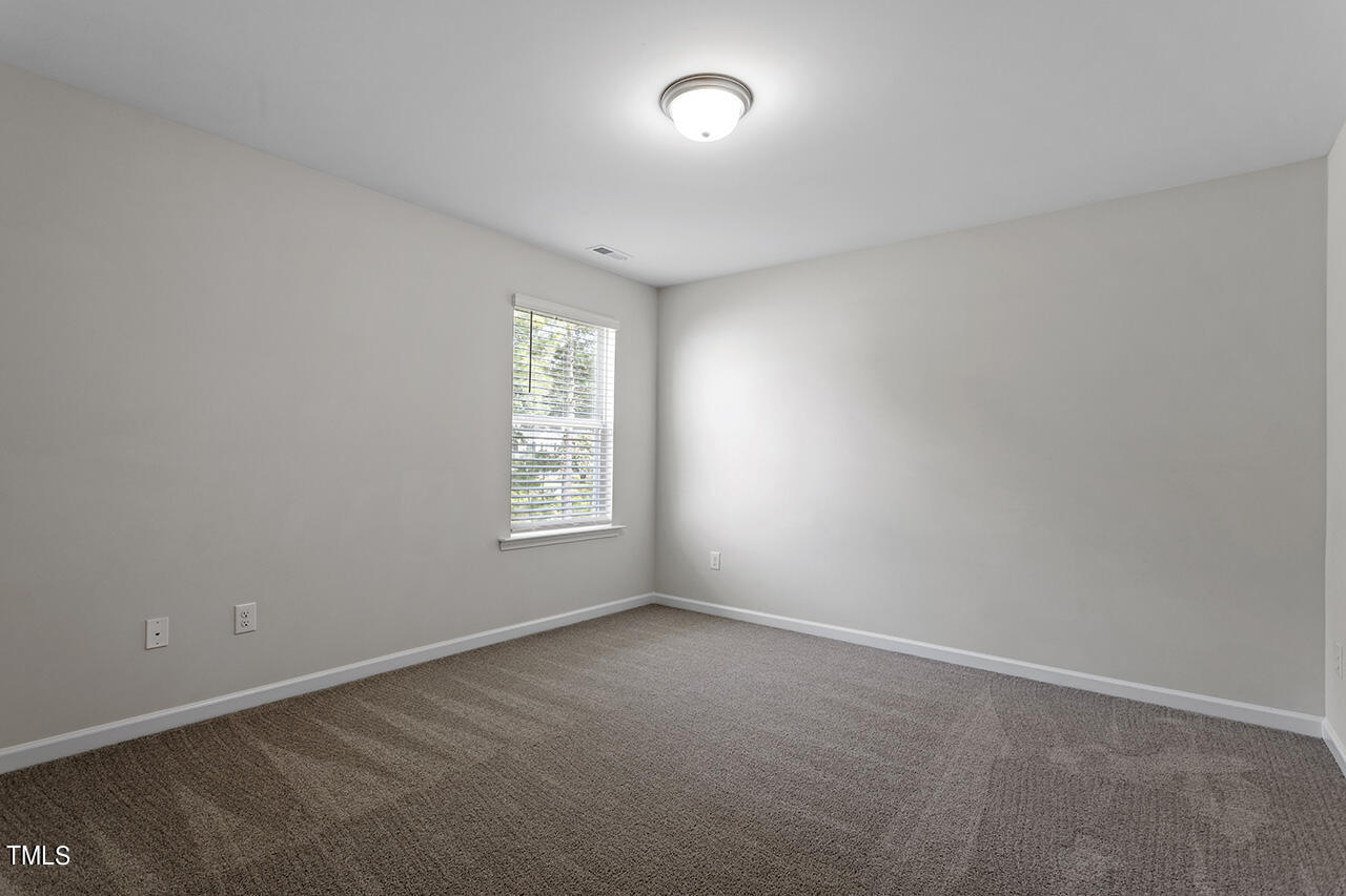 131 Hopper Circle Clayton, NC 27520 - Photo 27 of 39 an empty room with windows