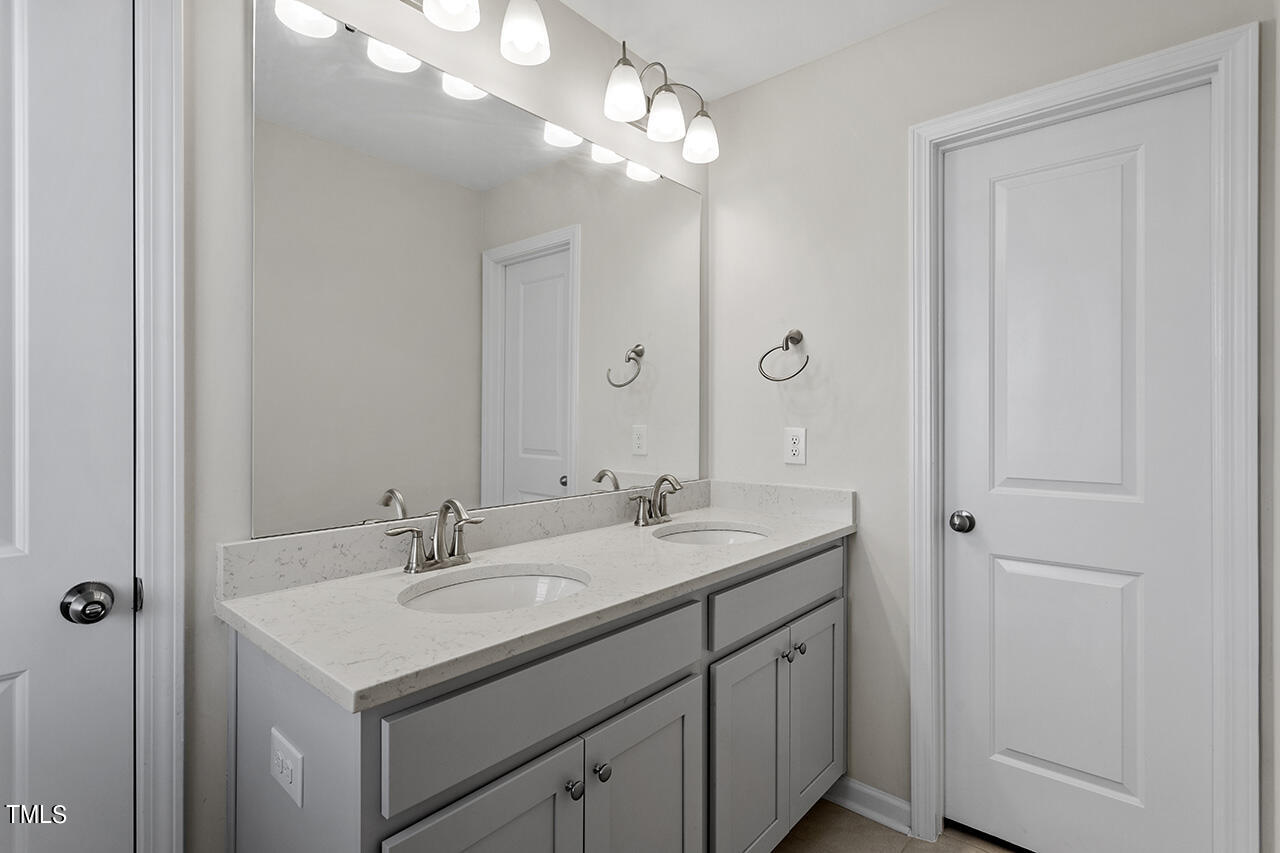 131 Hopper Circle Clayton, NC 27520 - Photo 29 of 39 a bathroom with a sink double vanity and a mirror