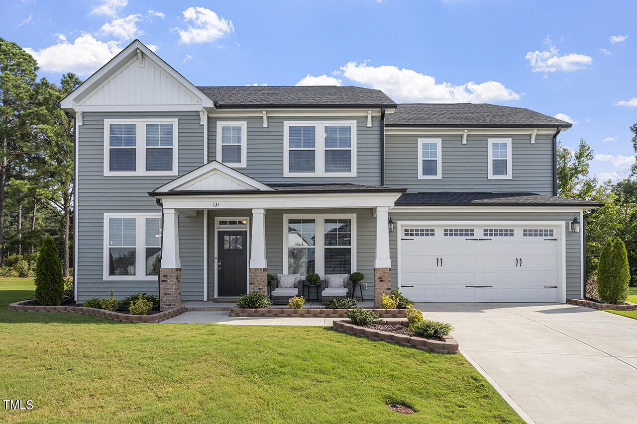 131 Hopper Circle Clayton, NC 27520 - Photo 3 of 39 a front view of a house with a yard and garage