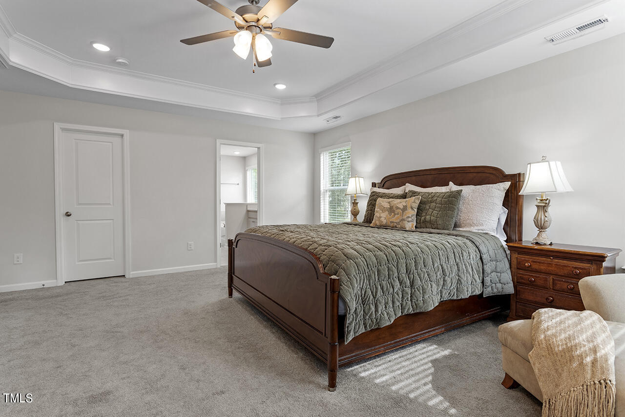 131 Hopper Circle Clayton, NC 27520 - Photo 34 of 39 a bedroom with bed and window