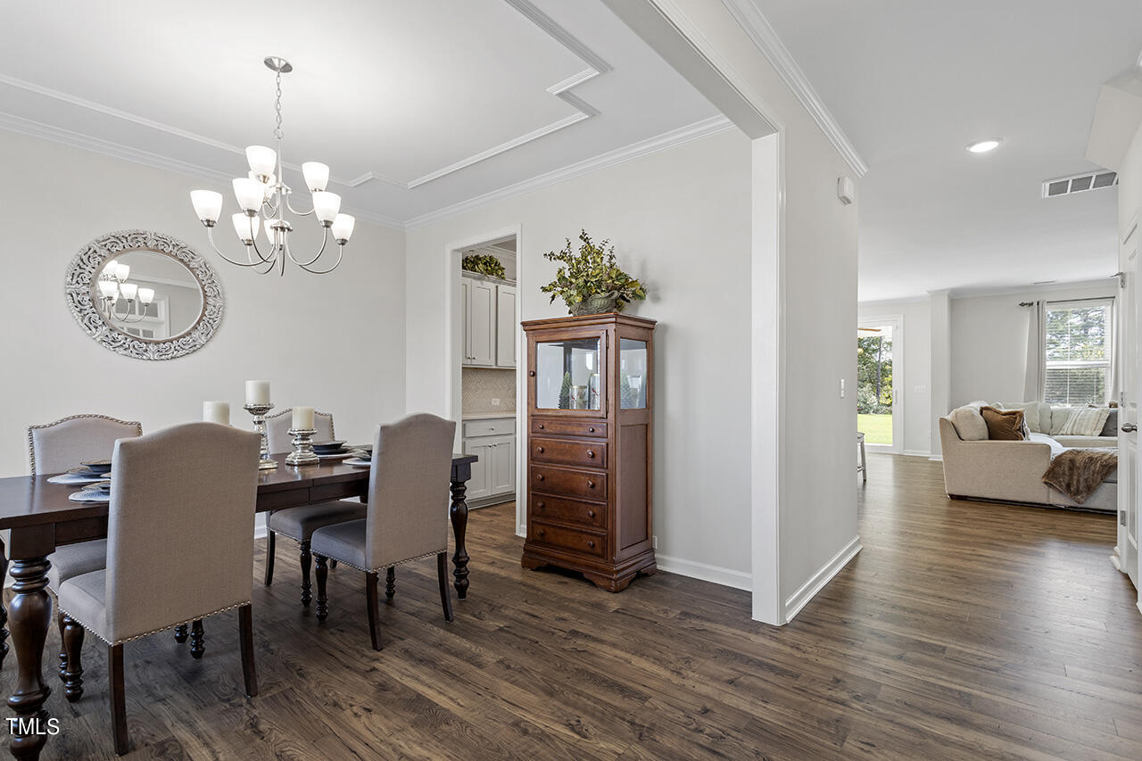 131 Hopper Circle Clayton, NC 27520 - Photo 8 of 39 a view of a dining room with furniture wooden floor and chandelier