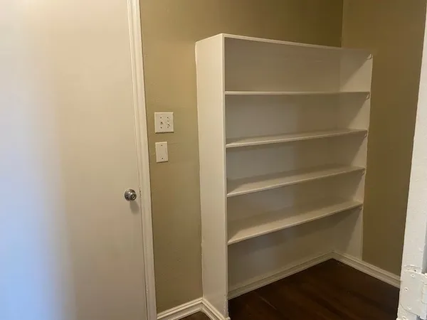 a view of walk in closet with empty racks